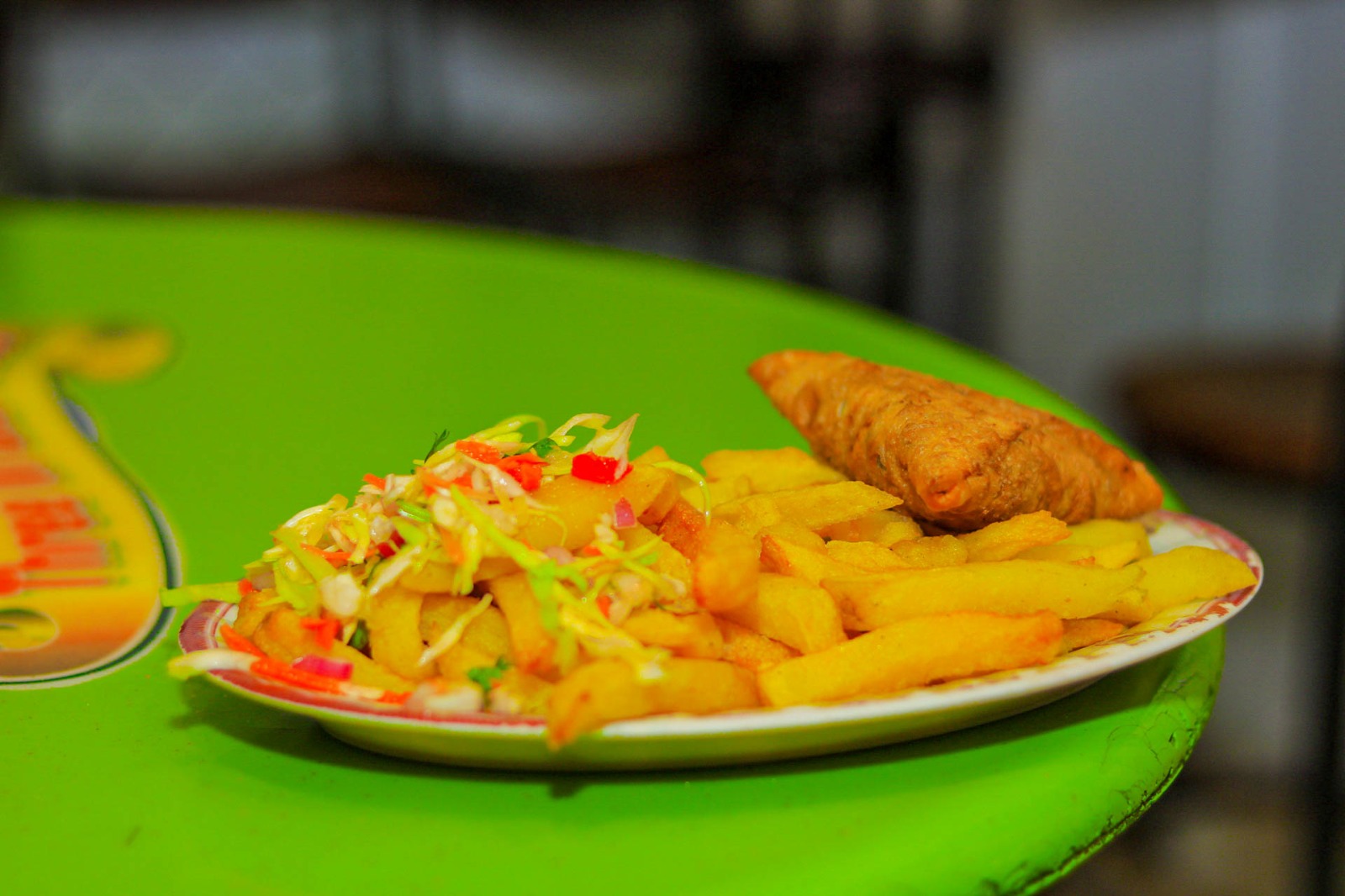 Fries served with coleslaw and a golden samosa