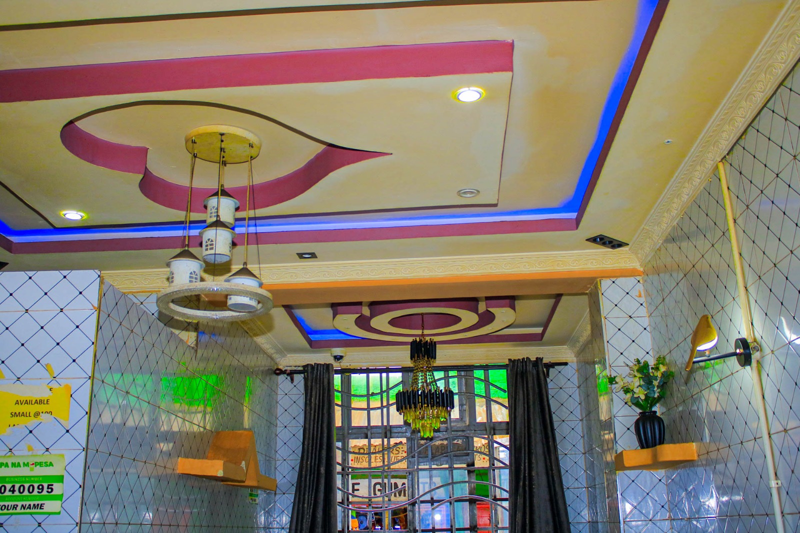 Chandelier and decorated ceiling inside Three In One